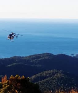 helicopter over forest and coast nz